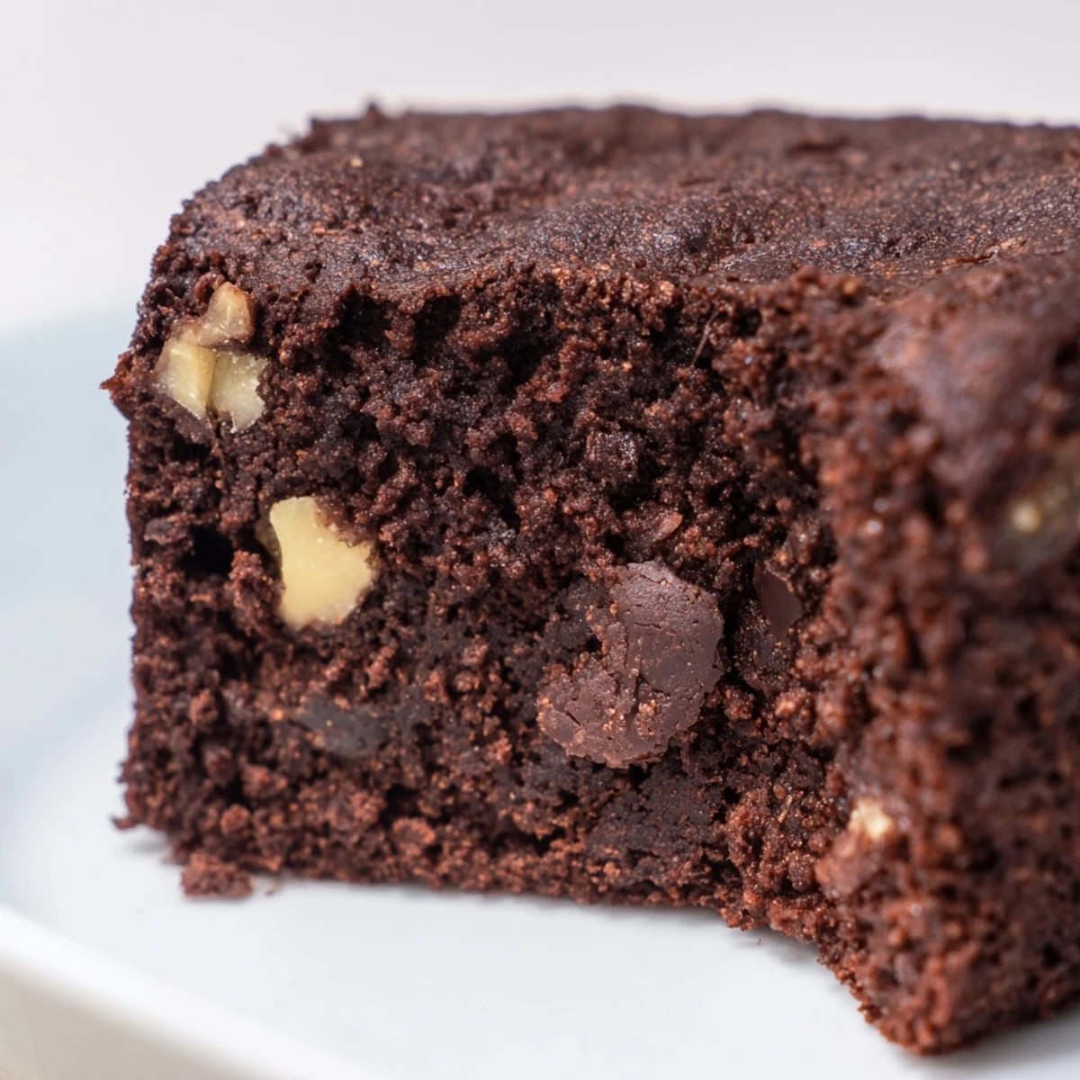 Gluten Free Almond Flour Brownies stacked high, showcasing a moist, fudgy crumb and chopped walnuts for a decadent gluten-free dessert.