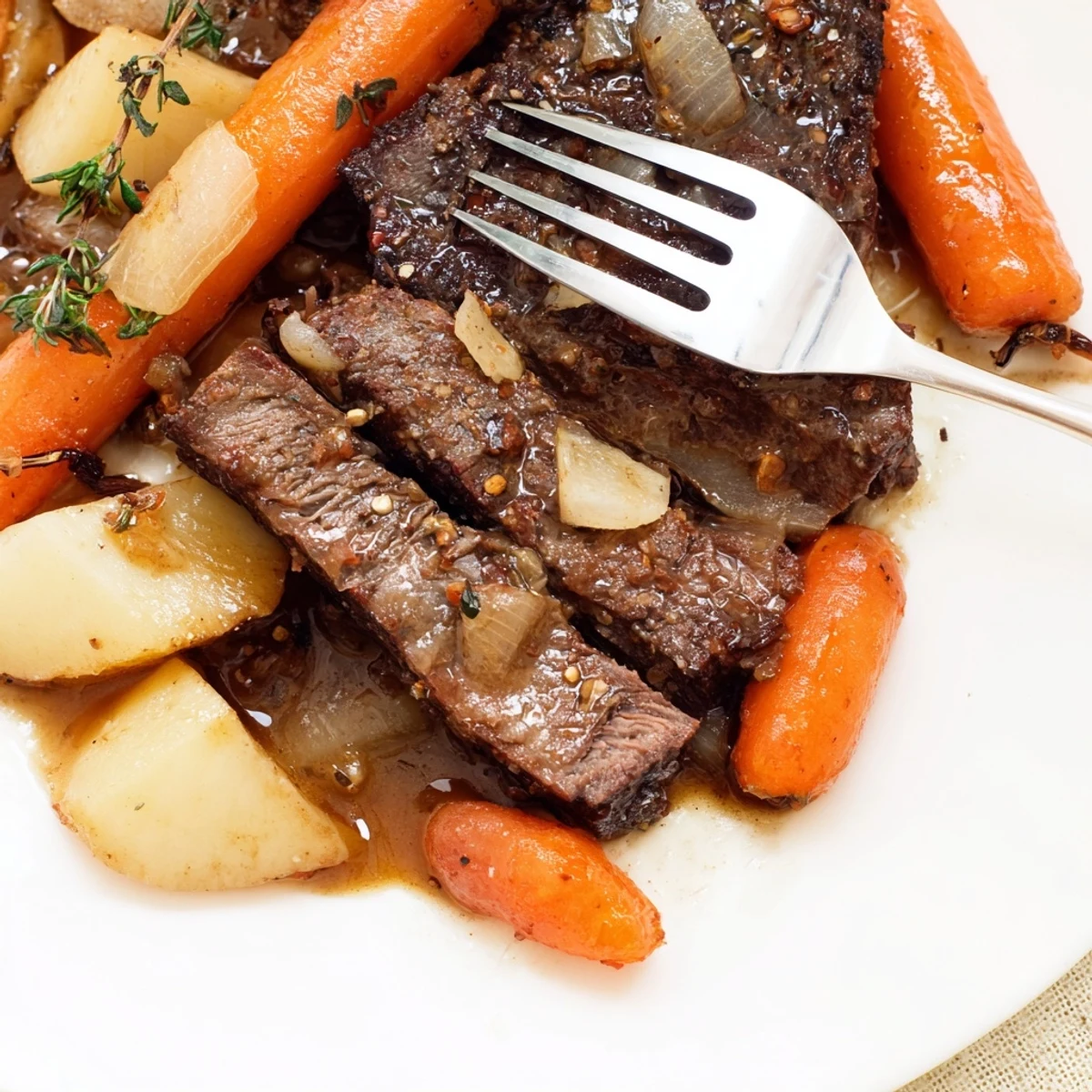 Fork-tender Slow Cooker Roast Beef with soft carrots and potatoes, served in a rich savory broth.