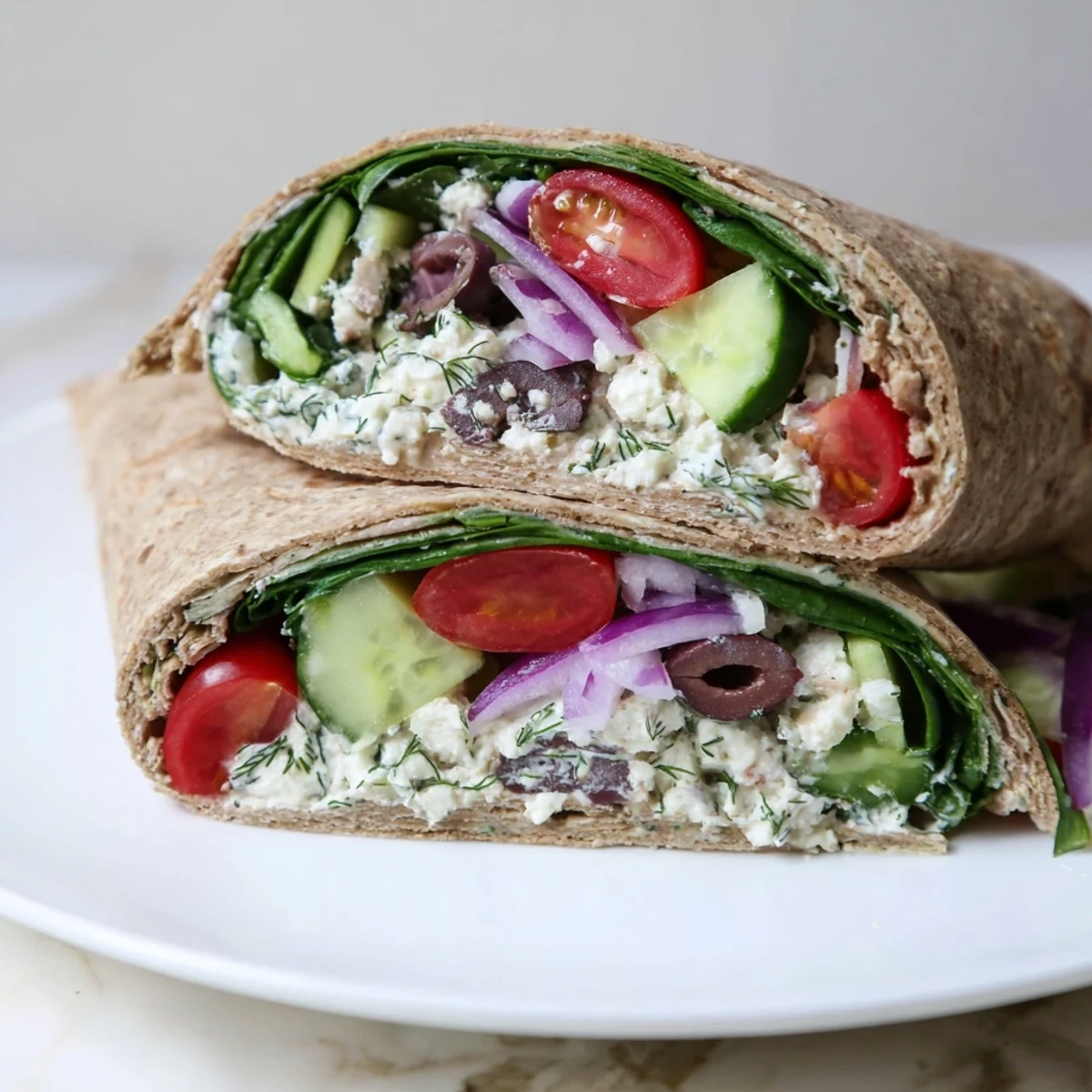 Perfectly rolled Mediterranean Wrap with Feta and Olives on a wooden board, ready for a quick vegetarian lunch.