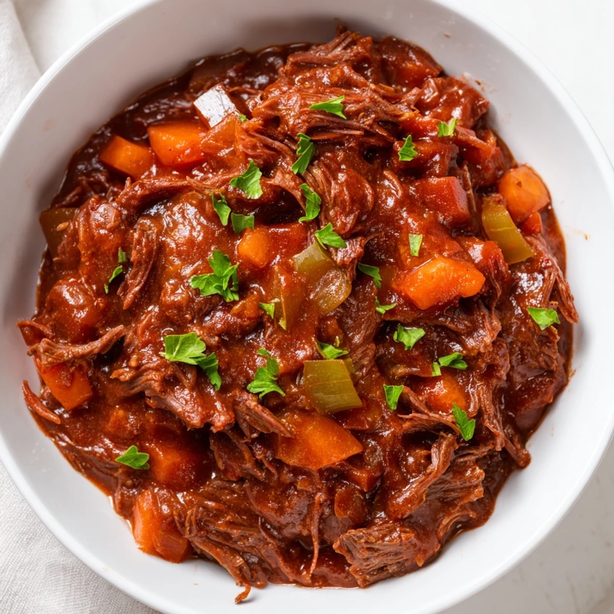 Tender beef chunks simmered in a rich, tomato-based Slow Cooker Ragu sauce, served over creamy polenta.