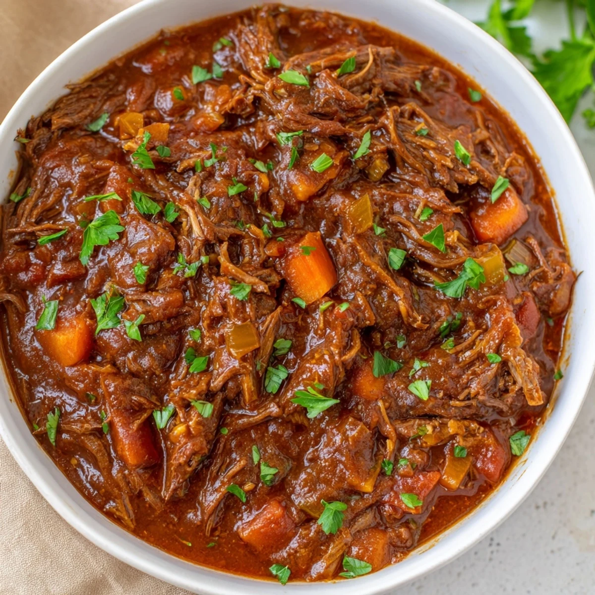 Hearty Slow Cooker Ragu with Beef bubbling in a slow cooker, garnished with fresh parsley and Parmesan.