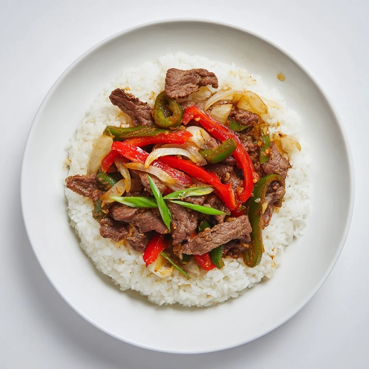 Hot, aromatic jasmine rice serves as the fluffy base for a vibrant spicy beef stir-fry.