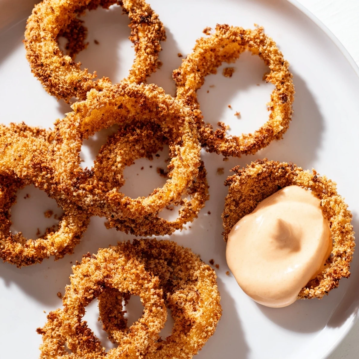 Crispy Air Fryer Onion Rings with Spicy Mayo served golden brown with creamy dip.