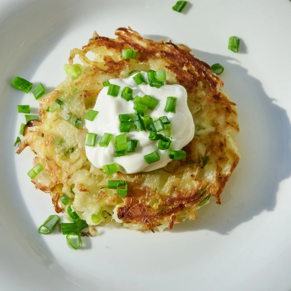 Hearty potato cakes with scallions, perfectly golden and served with tangy sour cream for dipping.
