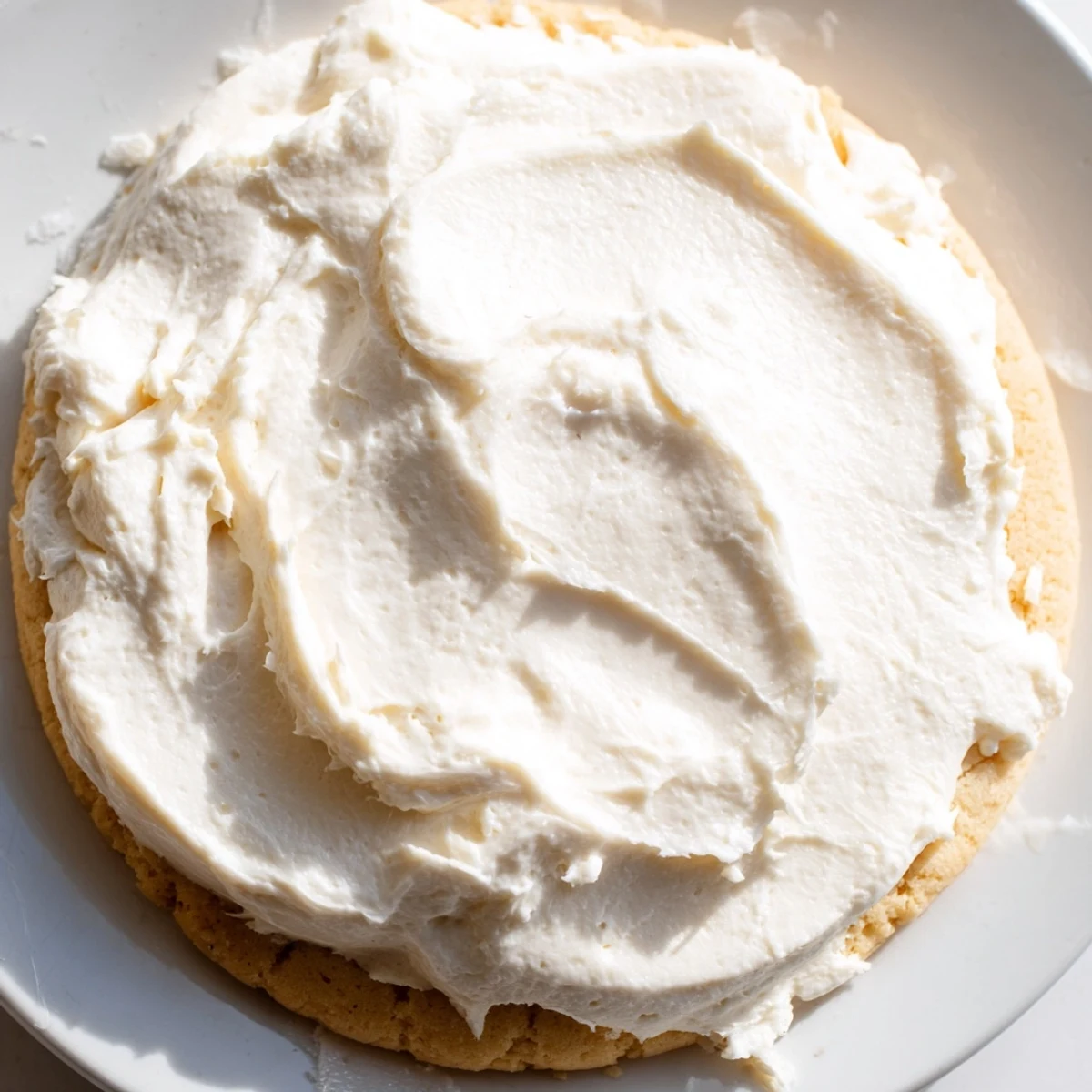 Fluffy Easy Sugar Cookie Frosting spread smoothly on a cooling rack, ready for decorating cookies with vibrant colors.