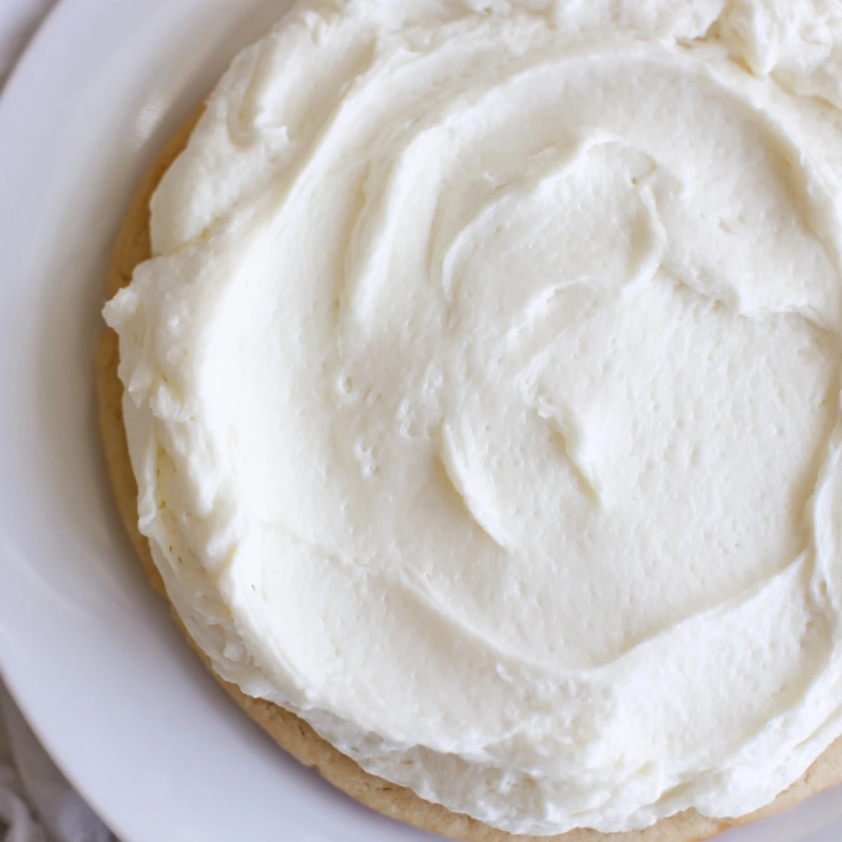 Easy Sugar Cookie Frosting in a mixing bowl, light vanilla buttercream ready to frost cookies for a festive American dessert.