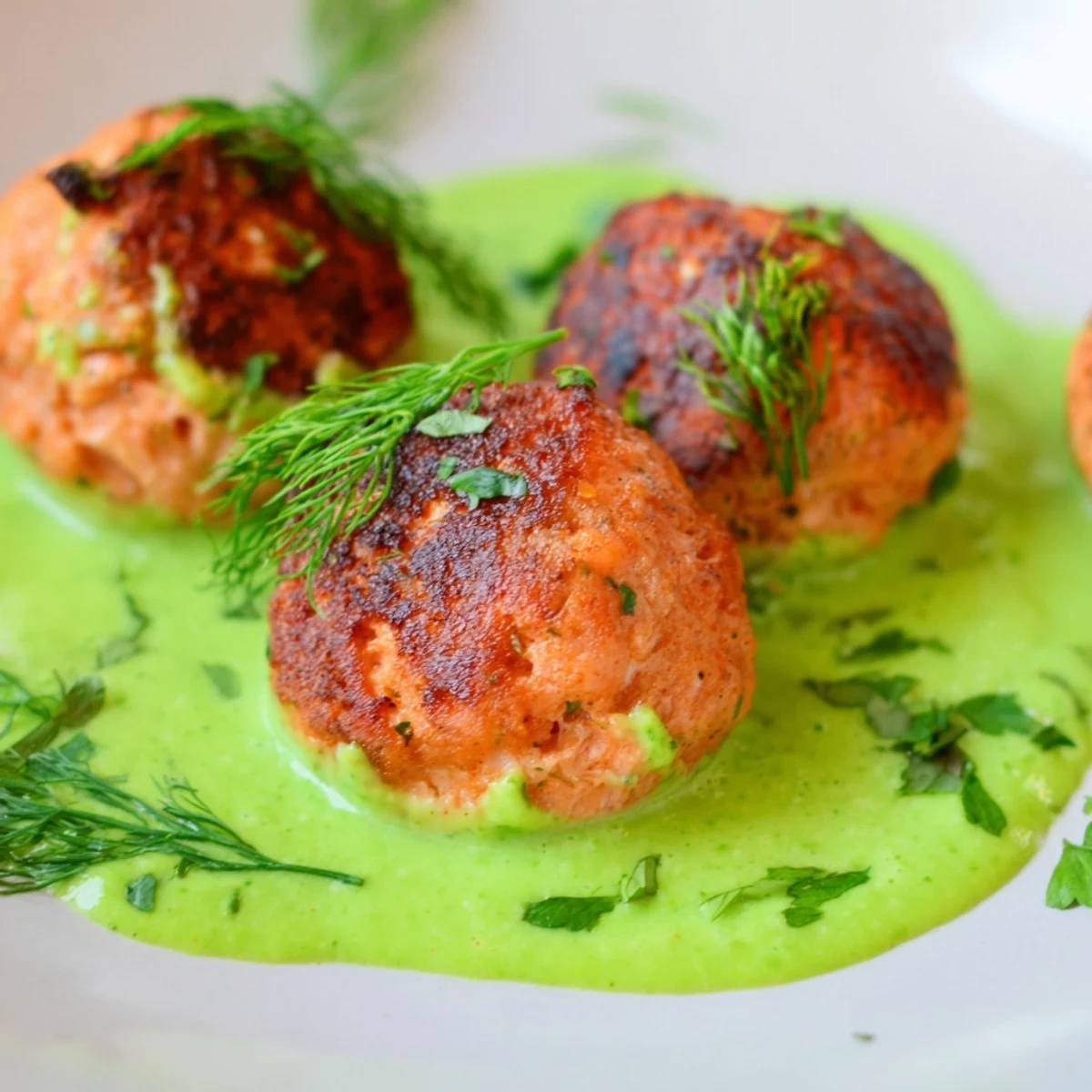 A close-up of flavorful salmon bites with smooth avocado sauce, perfect as a gluten-free appetizer or light main.