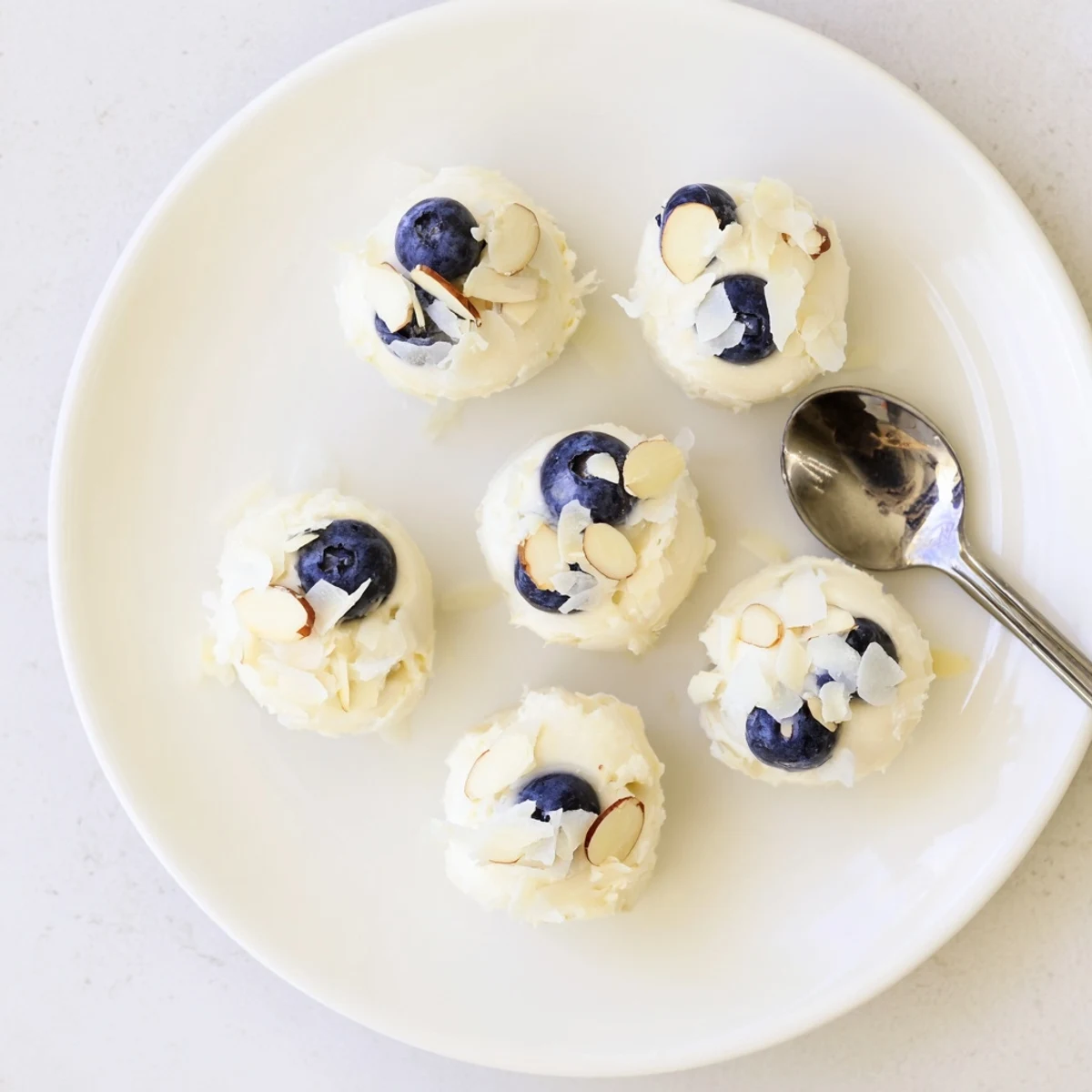 Blueberry Greek Yogurt Bites with fresh blueberries and a drizzle of honey.