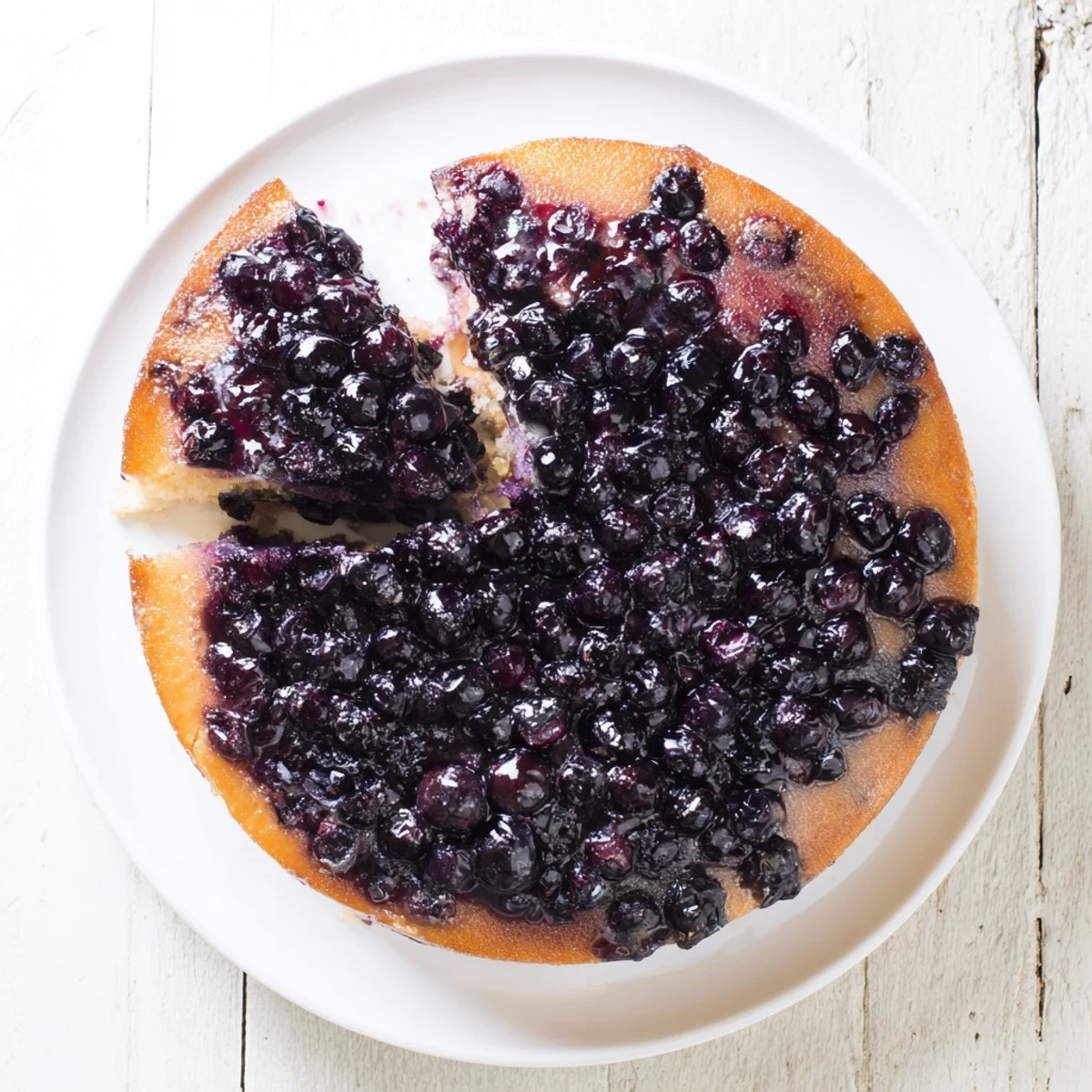 Moist blueberry upside down cake sliced to reveal juicy purple berry layers inside
