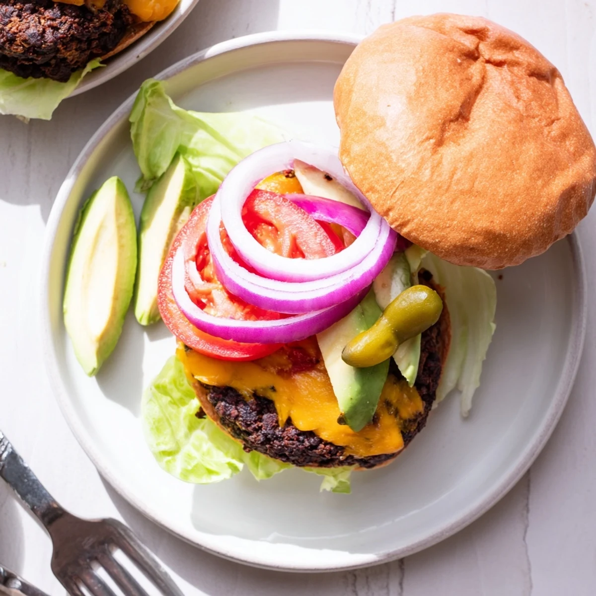 Vegetarian epic black bean burger on sesame bun with creamy mayo and ripe tomato slices
