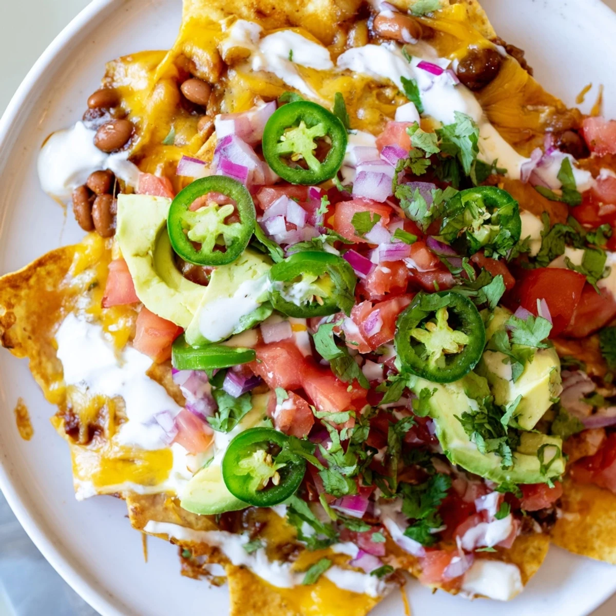 Crispy tortilla chips layered with savory baked beans and bubbling cheddar Monterey Jack