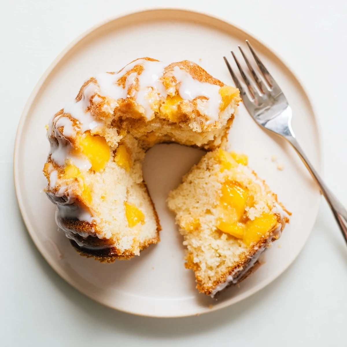 Buttery pound cake layered with spiced peach slices topped with sweet vanilla icing