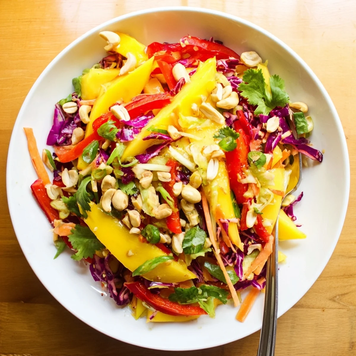 Vibrant mango slaw with crisp red cabbage and carrots in tangy lime dressing