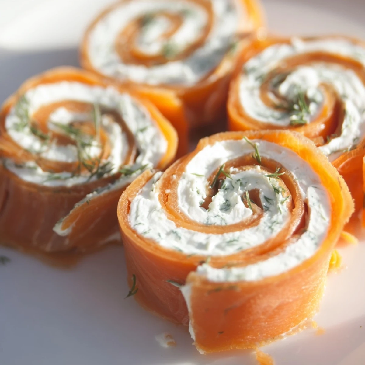 Elegant smoked salmon roll ups arranged on wooden board with fresh dill sprigs