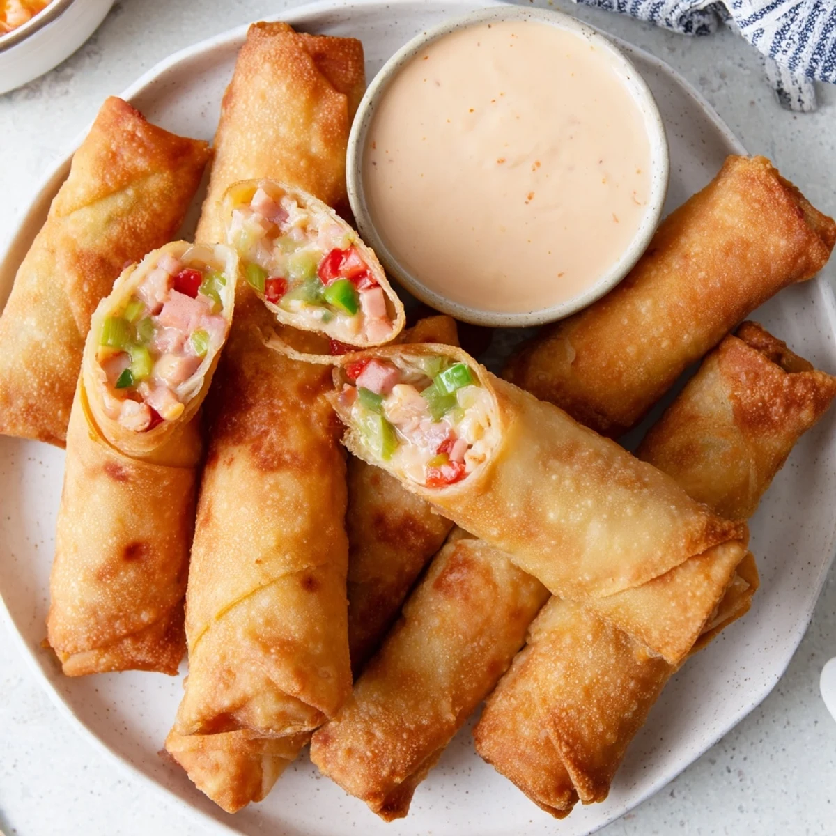 Golden fried Voodoo Egg rolls filled with spicy andouille sausage and colorful bell peppers