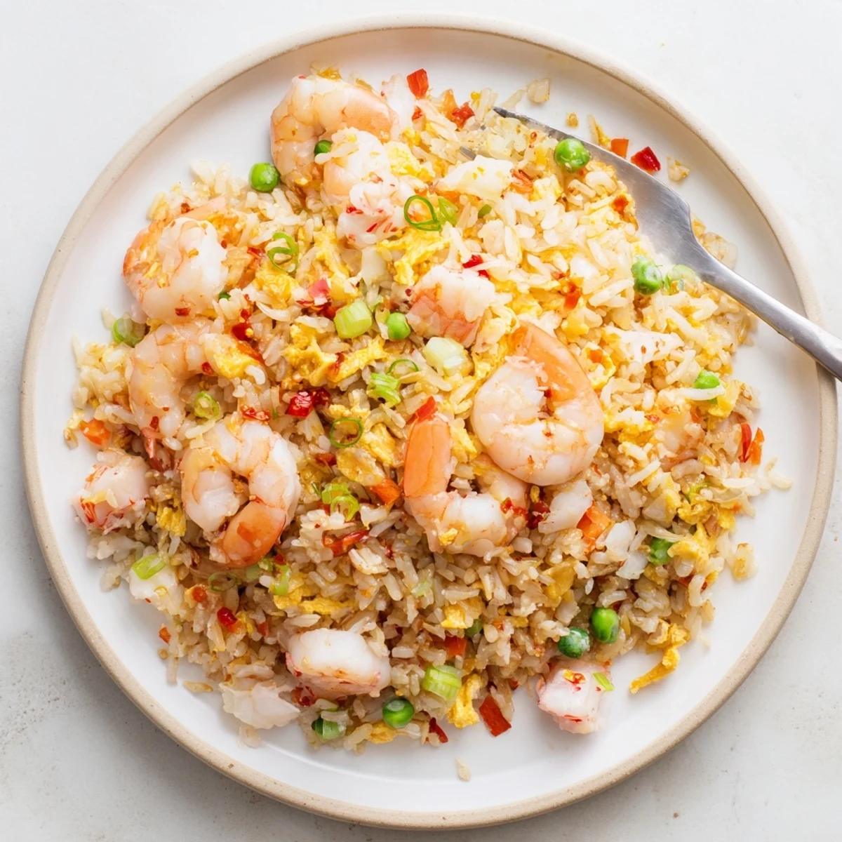 Steamy plate of Asian fusion fried rice loaded with succulent shrimp and crab topped with spicy homemade chili oil