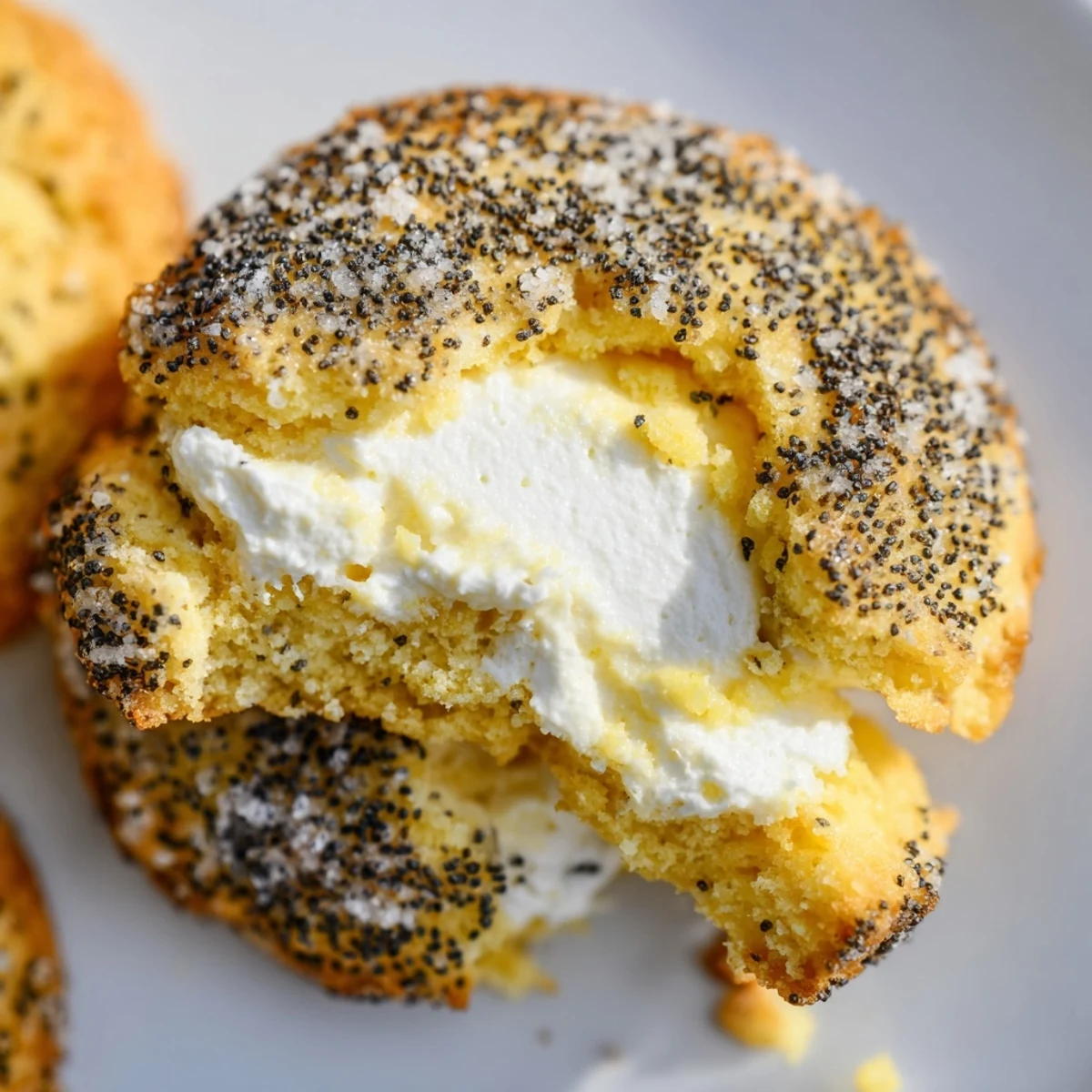 Freshly baked lemon poppy seed cheesecake cookies on cooling rack with visible poppy seeds