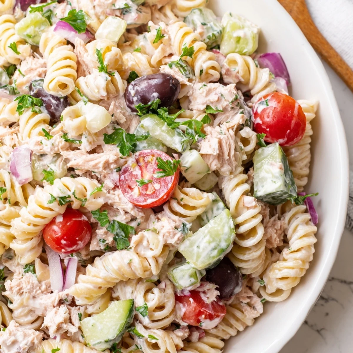 Chilled tuna pasta salad featuring tender noodles, flaky tuna, and vibrant diced vegetables