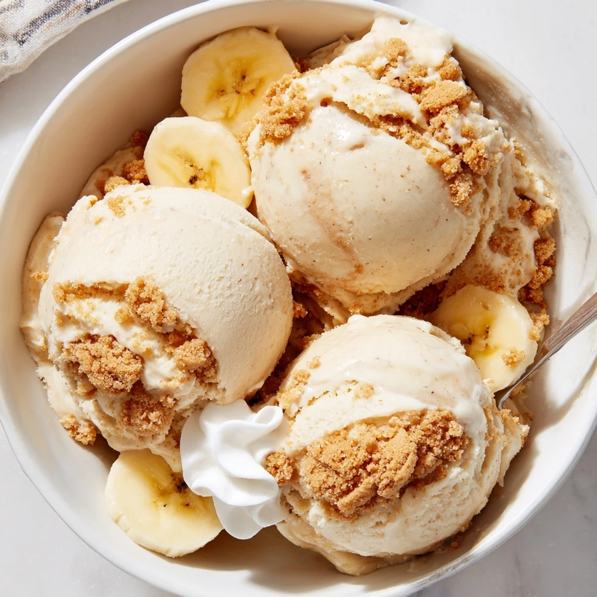 Chilled Ninja Creami Banana Cream Pie Ice Cream topped with whipped cream