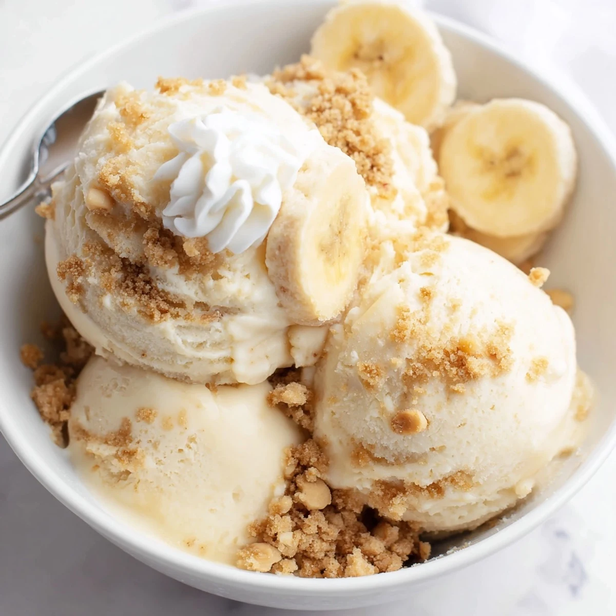 Spoonful of Ninja Creami Banana Cream Pie Ice Cream melting slightly