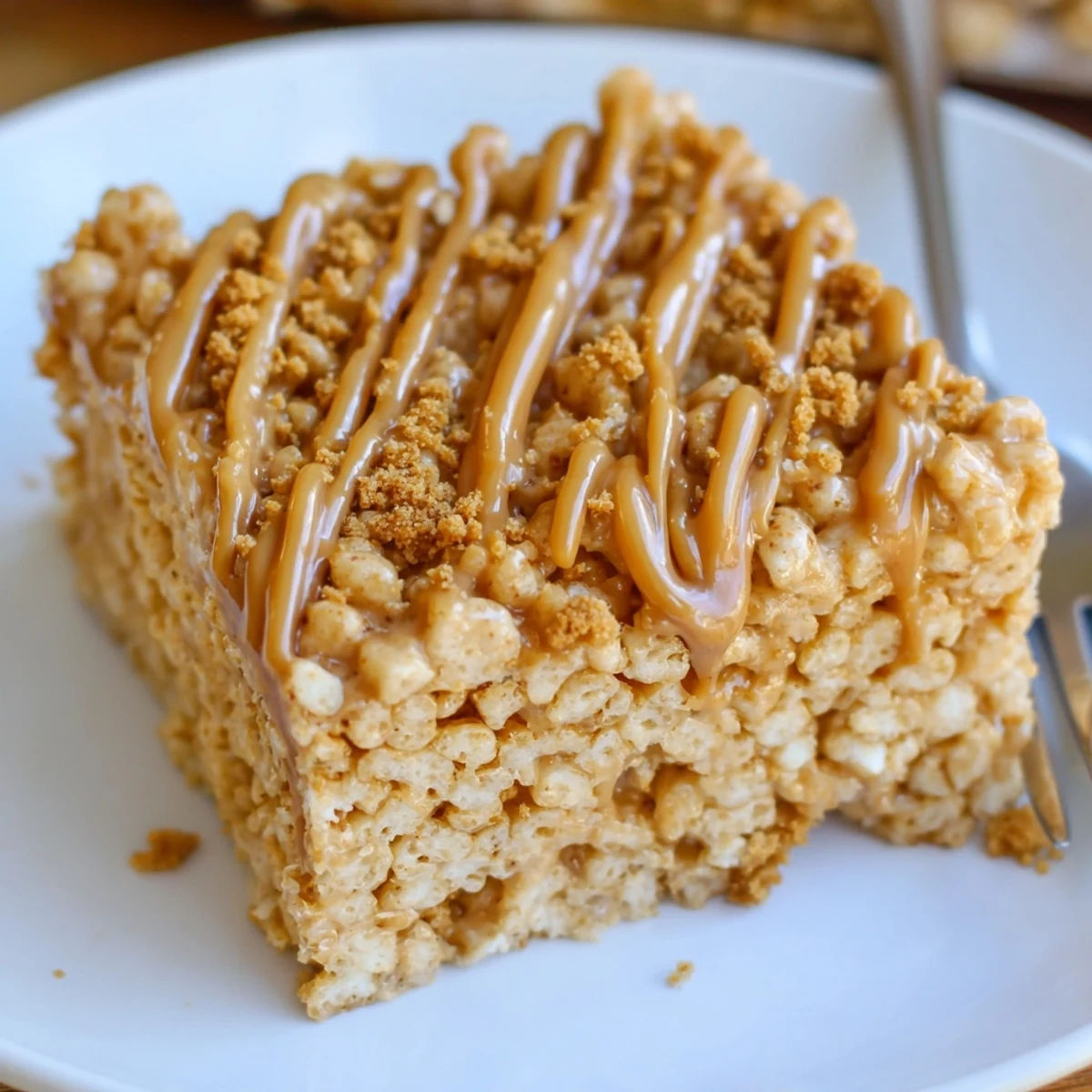 Stacked Biscoff Rice Krispie Treats cut into squares, crunchy caramel flavor.