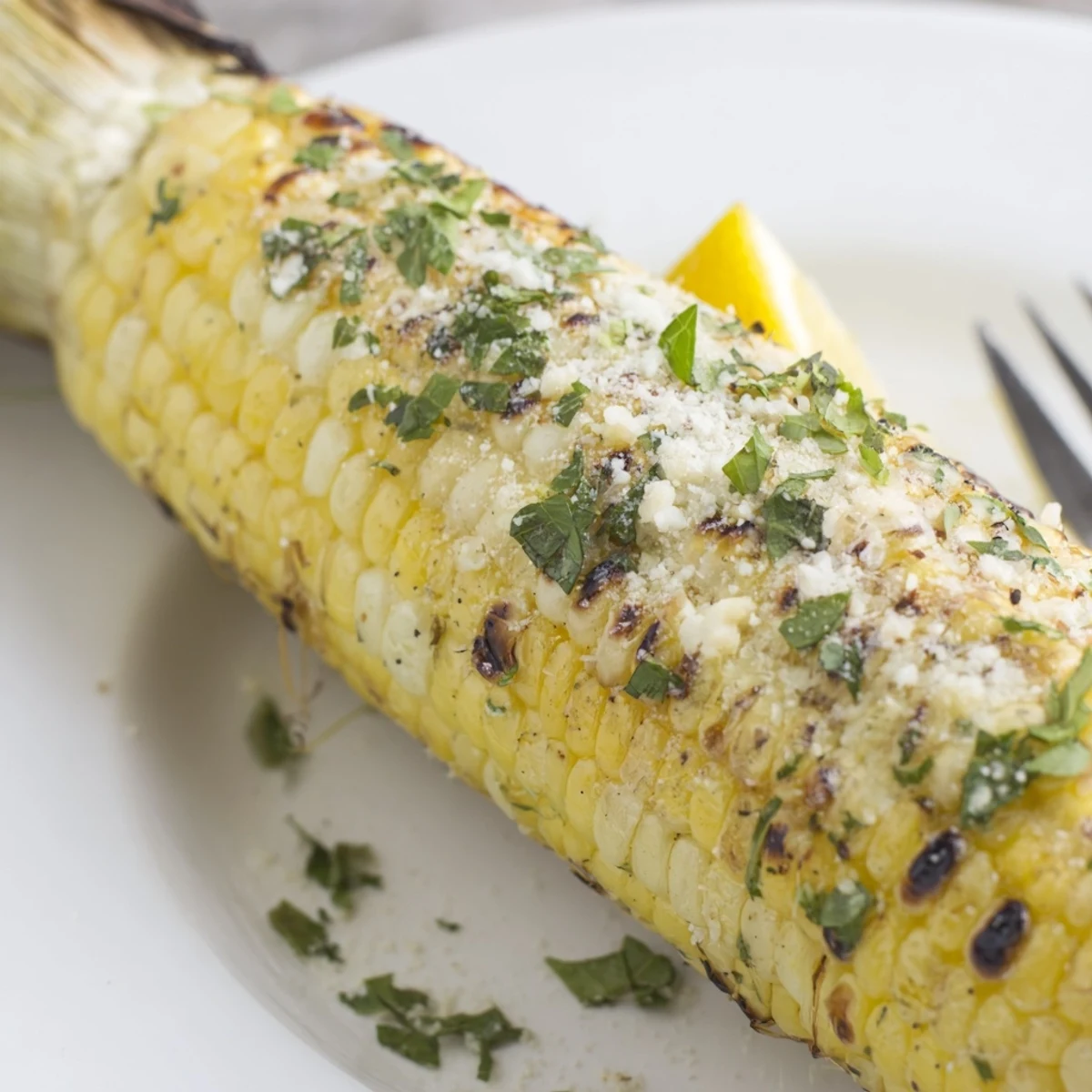 Hot Garlic Parmesan Corn On The Cob brushed with garlic butter, ready to serve.