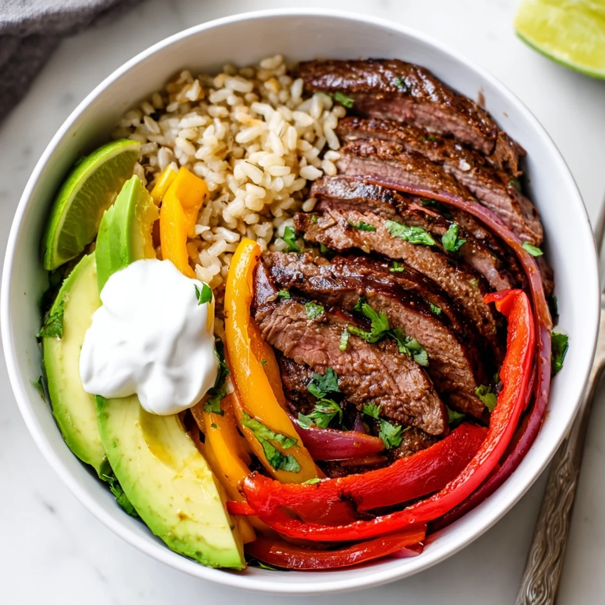 Overhead bowl of Steak Fajita Power Bowls: tender steak, avocado, cilantro