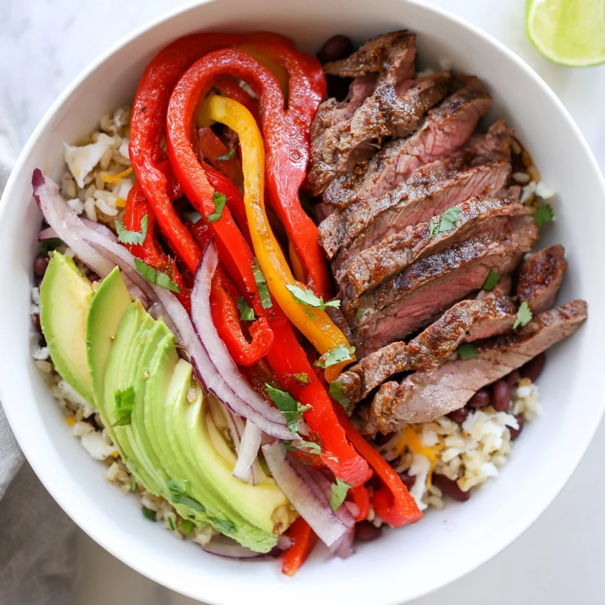 Family-style Steak Fajita Power Bowls served warm with rice, beans, cheese