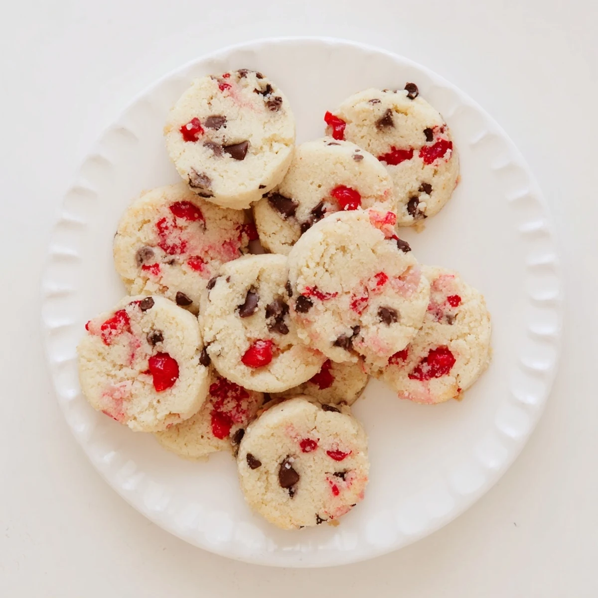 Homemade Christmas maraschino cherry shortbread showing tender crumb texture with colorful cherry pieces scattered throughout the buttery dough
