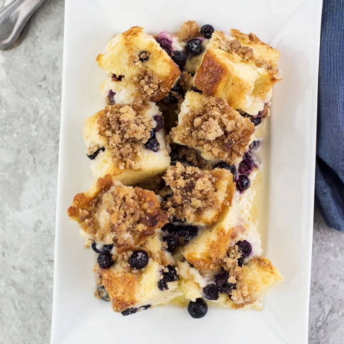 Breakfast casserole featuring blueberry cream cheese French toast with golden brown edges