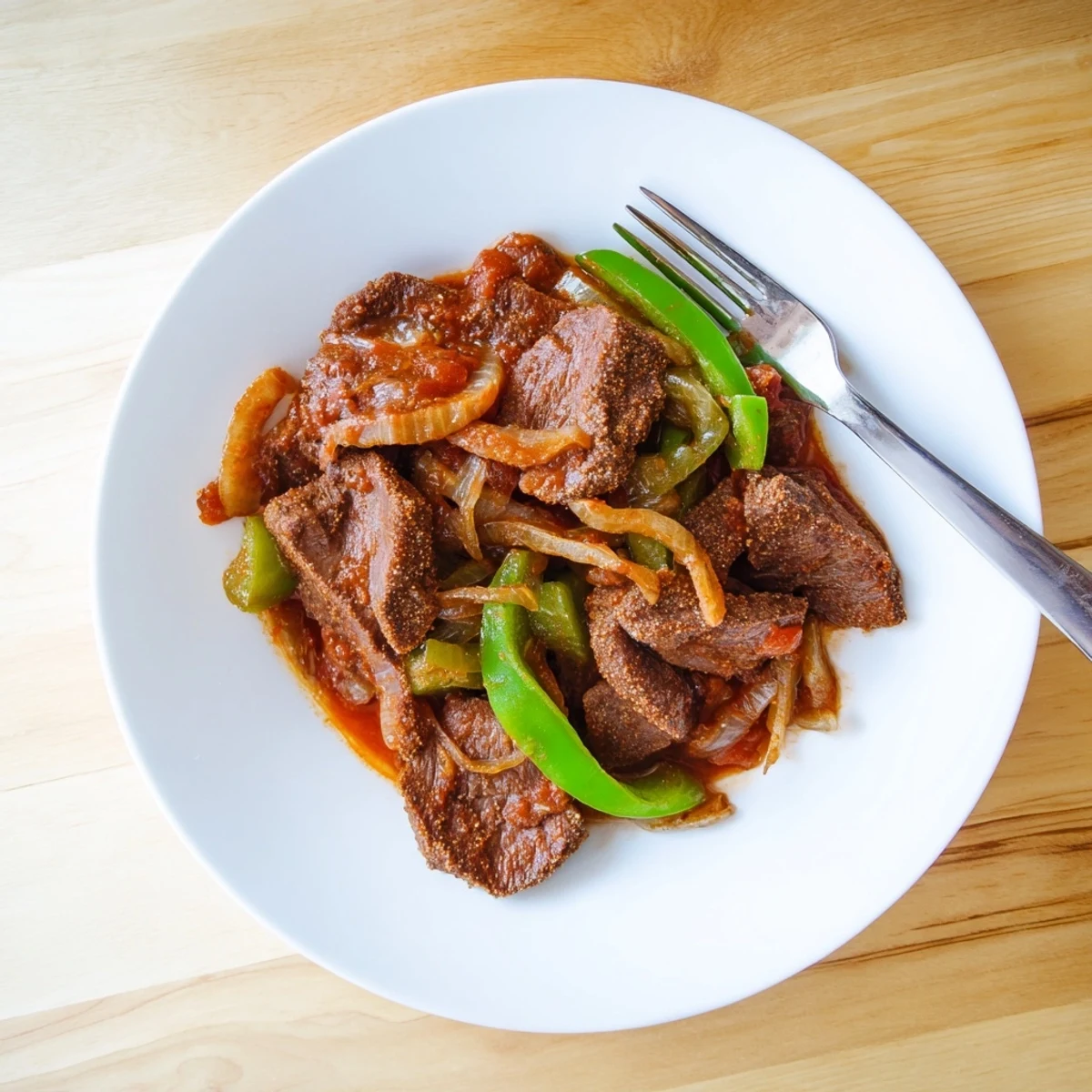 Tender old fashioned Swiss steak with beef braised in rich tomato sauce