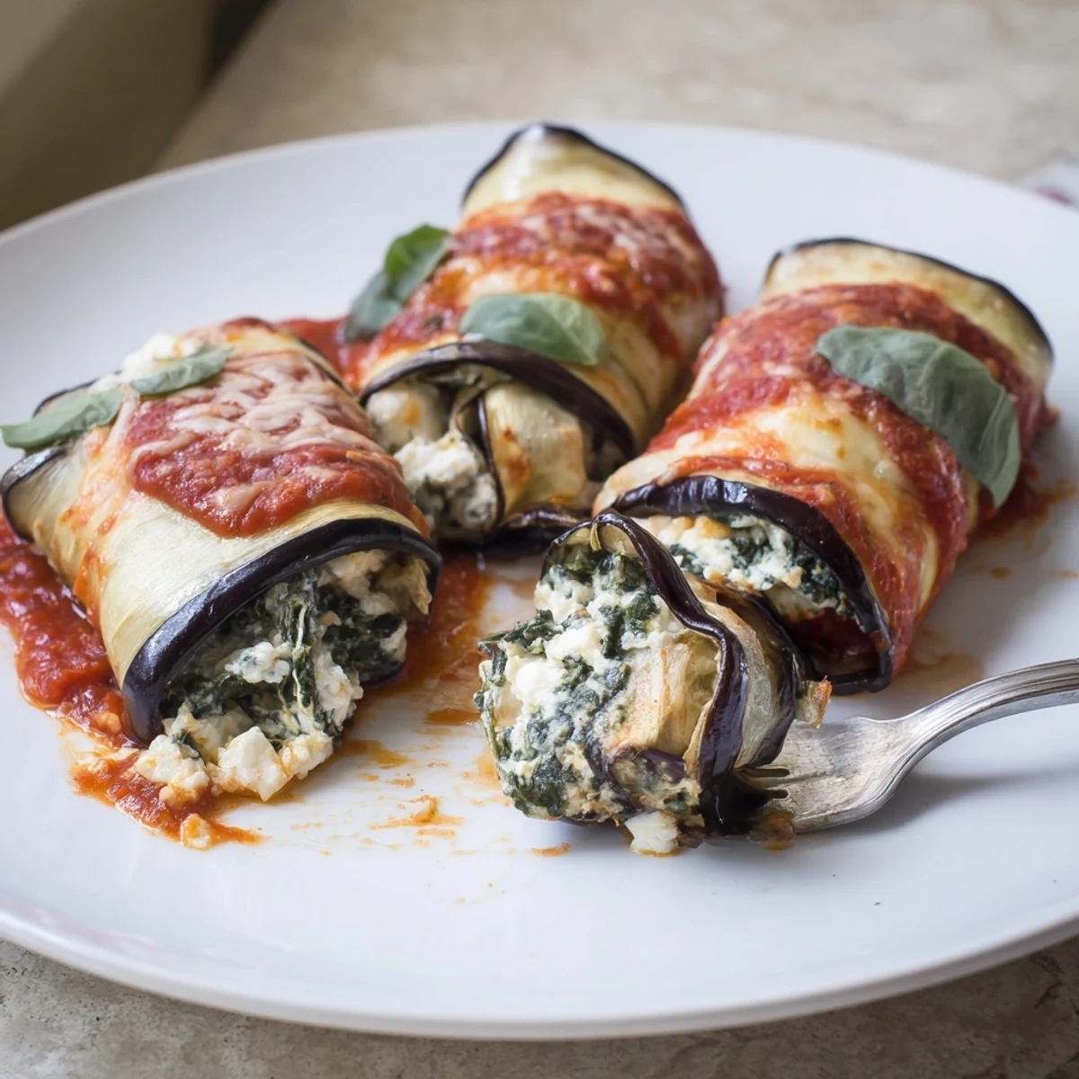 Warm, creamy ricotta-filled Healthy Eggplant Rollatini served alongside crusty whole-grain bread