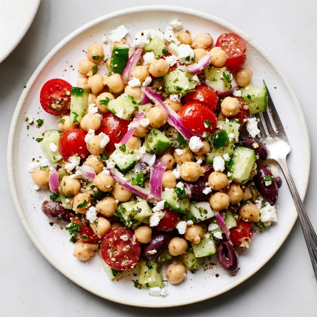 Chilled Mediterranean Chickpea Salad with Cucumber & Feta, tangy lemon dressing and crisp cucumber