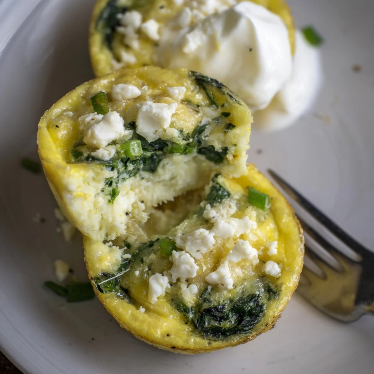 Warm Savory Spinach Feta Egg Bites steaming on a rustic breakfast plate