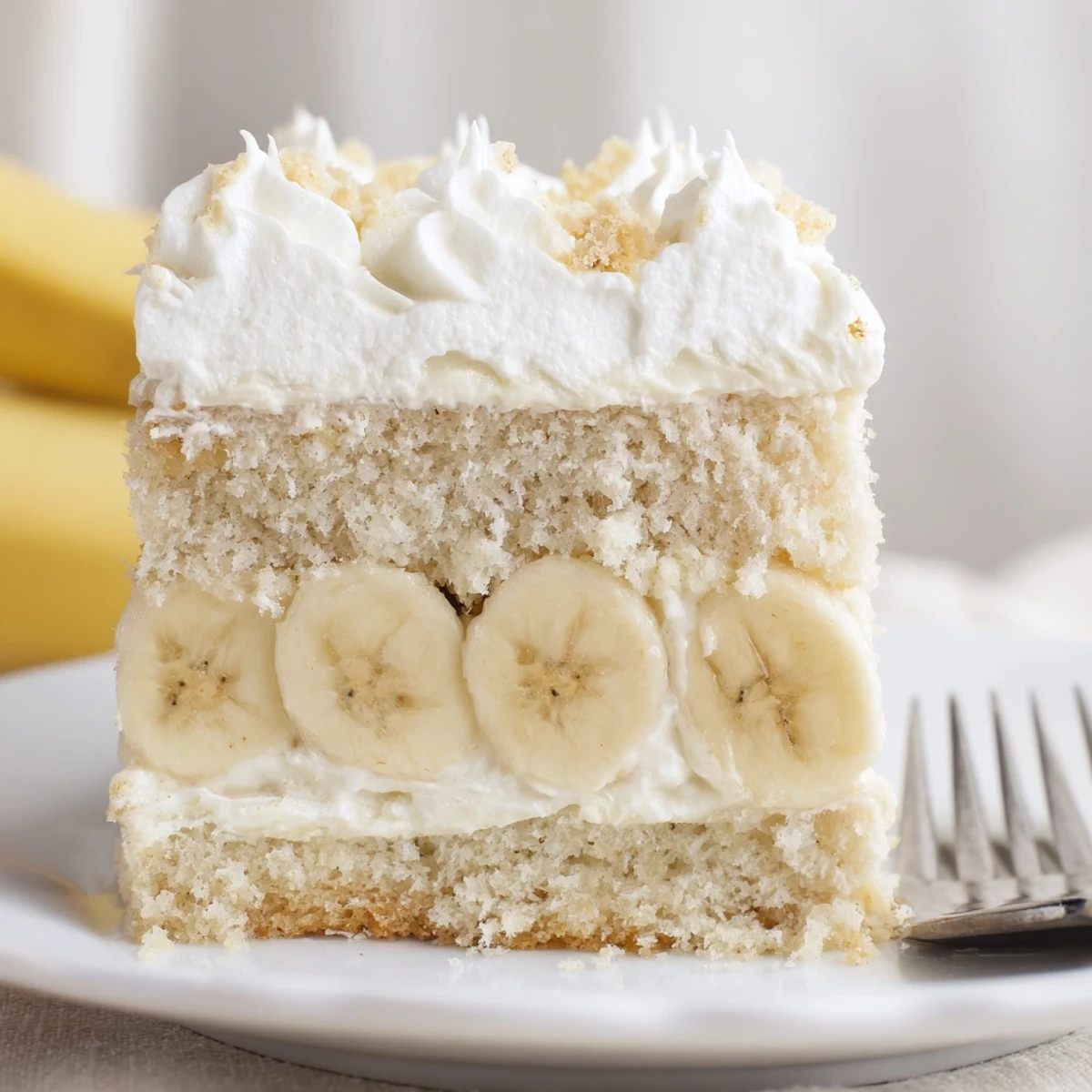 A slice of Banana Pudding Cake Recipe on plate, moist crumb, nostalgic flavor.
