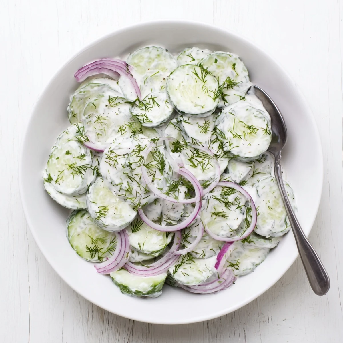 Refreshing Greek yogurt cucumber salad served cold with tangy yogurt sauce and herb garnish