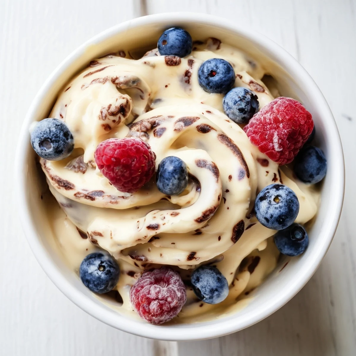 Ripe frozen bananas blended into smooth dairy-free healthy nice cream with dark chocolate shavings sprinkled on top