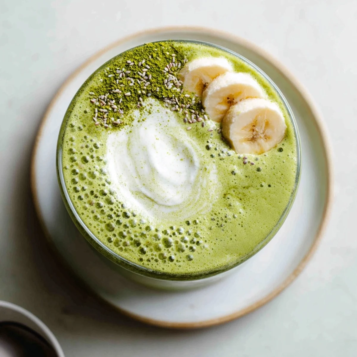 Matcha Smoothie poured into tall glass, creamy green swirl, chilled and refreshing