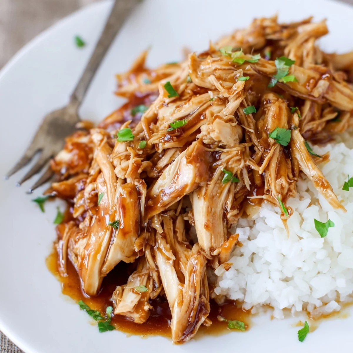 Weeknight Crockpot Honey Garlic Chicken shredded and tender, savory sweet sauce served with vegetables