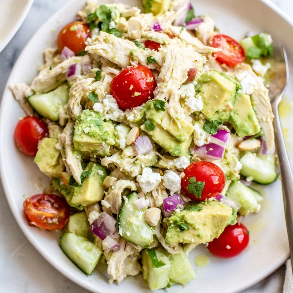 Picnic ready Avocado Chicken Salad served in lettuce wraps, sprinkled with feta.