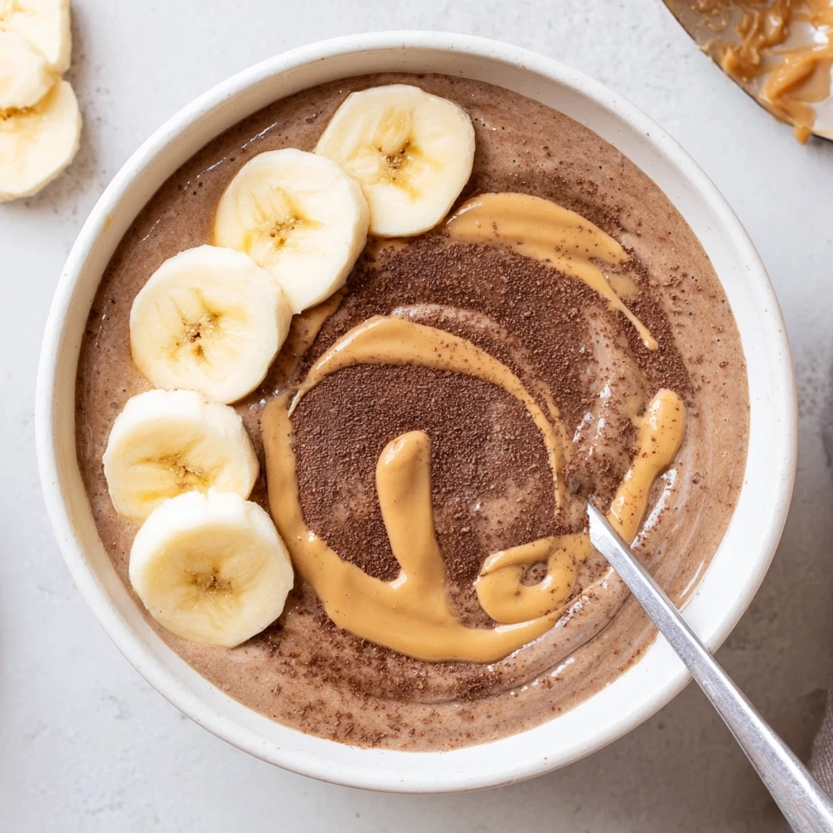 Rich Chocolate Peanut Butter Banana blend, silky texture with cocoa dusting