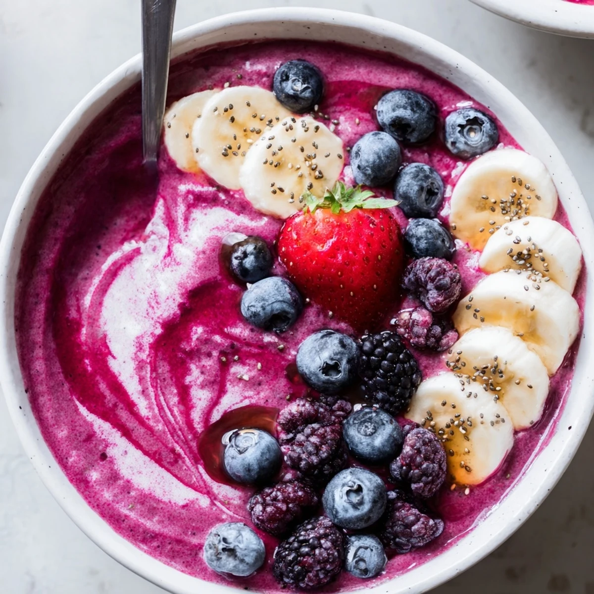 Creamy Summer Berry Smoothie topped with chia seeds and crunchy granola
