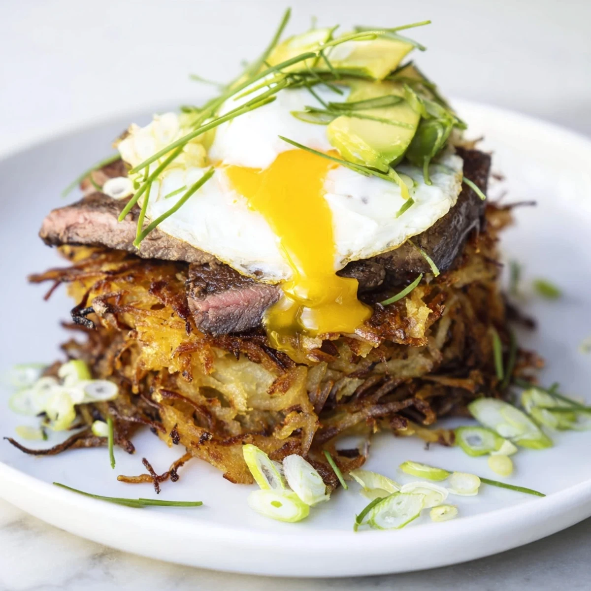 Loaded Steak Egg Hash Brown Stacks Recipe piled high, crispy edges, runny yolk  