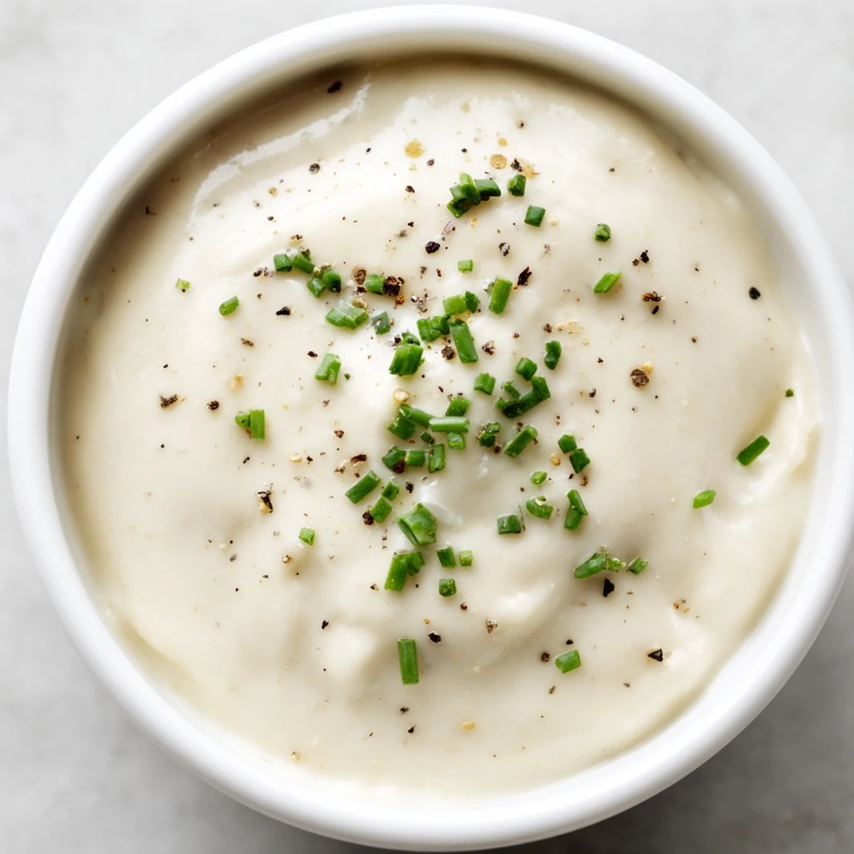 Zesty horseradish sauce drizzled over slices of tender roast beef on platter