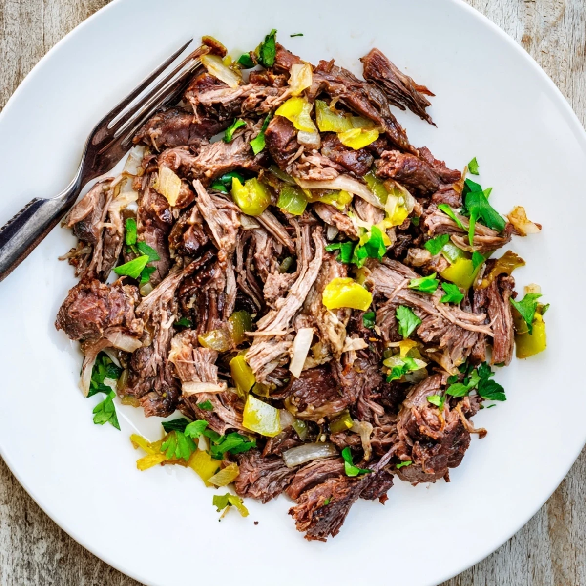 Tender slow cooker beef barbacoa shredded into juicy spicy Mexican-style meat perfect for tacos