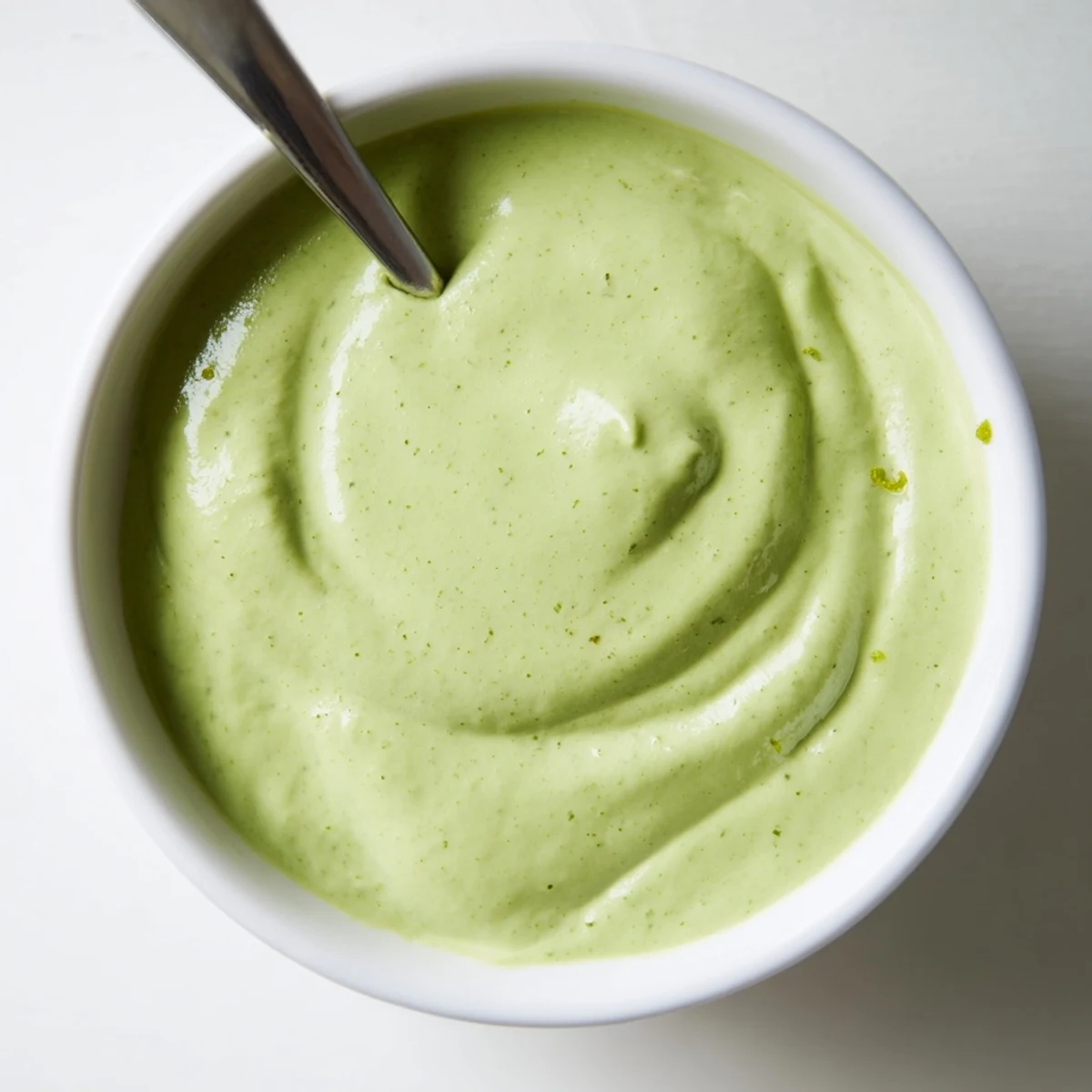 Creamy cilantro lime sauce drizzled generously over crispy street tacos with fresh garnishes