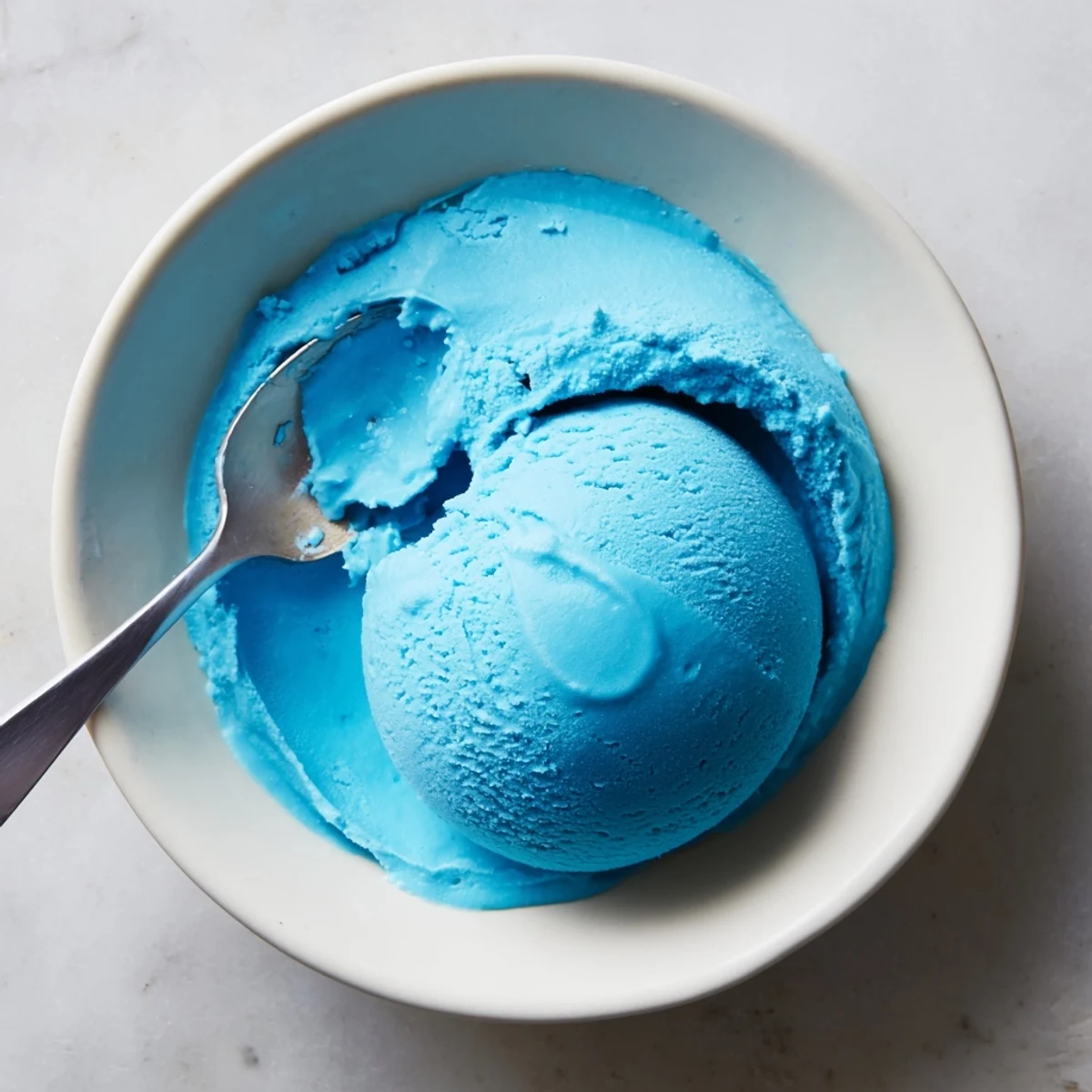Homemade Blue Moon ice cream with a vivid blue hue in a frozen custard scoop