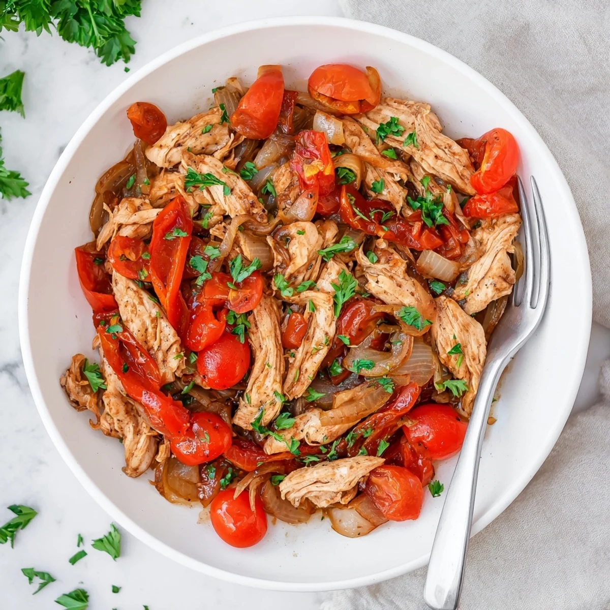 Tender Slow Cooker Balsamic Chicken plated atop fluffy white rice drizzled with rich, dark pan juices