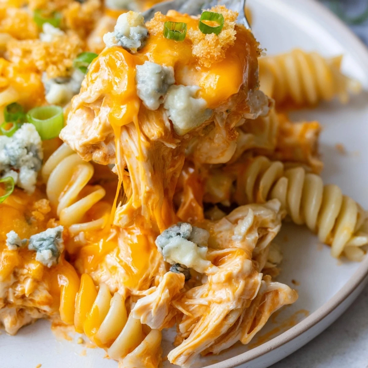 Creamy Cheesy Buffalo Chicken Dip Casserole bubbling with melted cheddar in a rustic baking dish