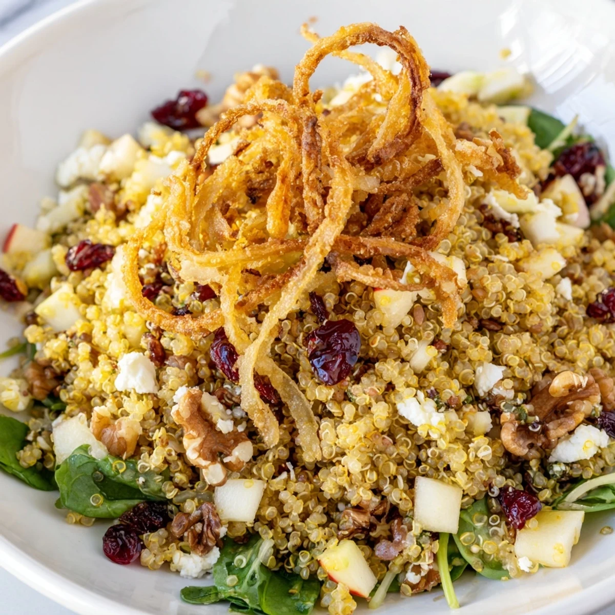 Colorful Honey Mustard Quinoa Apple Salad with diced apples, cranberries, and mixed greens tossed together